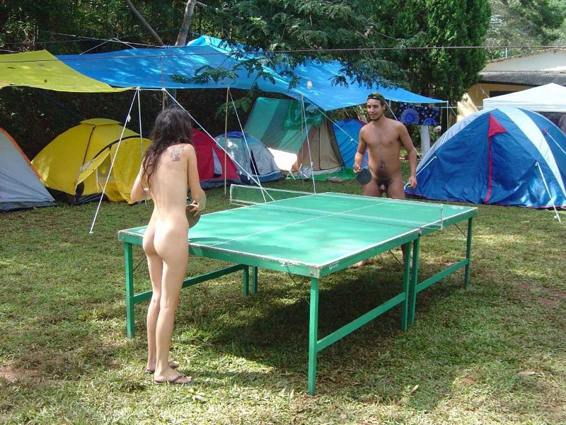 Two nude people playing table tennis