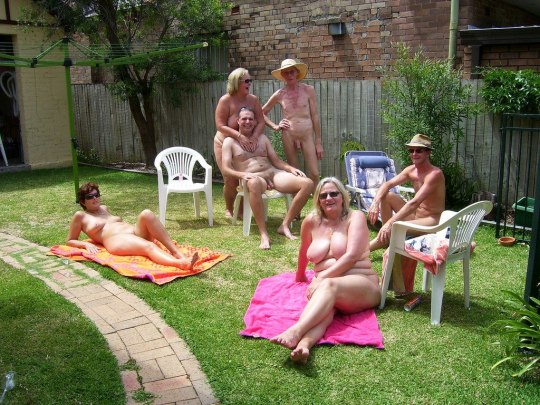 Friends in a garden, enjoying some nude time