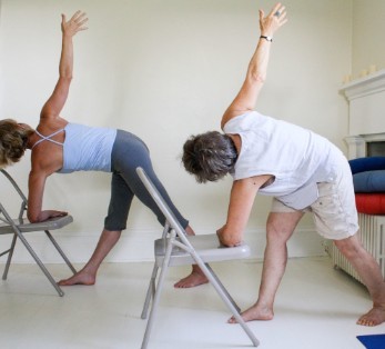 2 people doing chair yoga