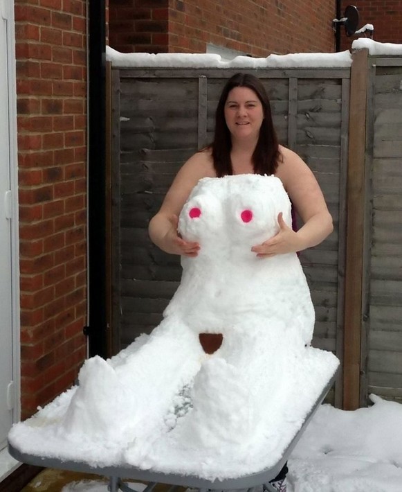 Naked woman behind a nude body made of snow