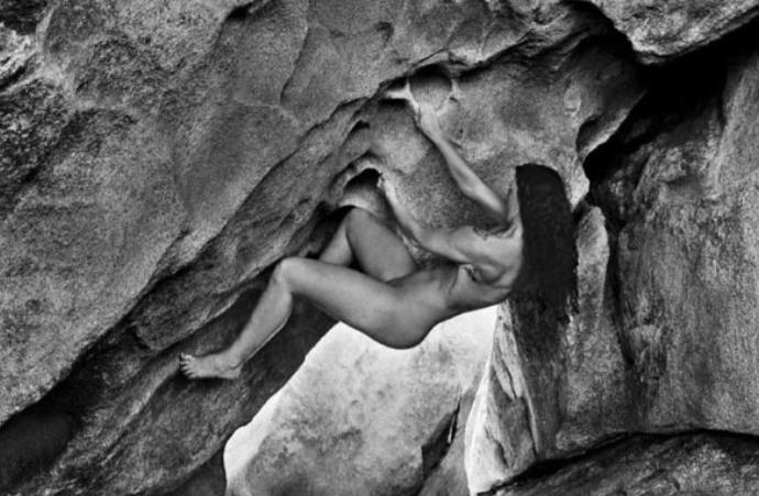 Nude rock climbing woman