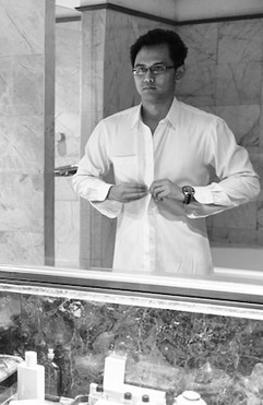 Man in mirror, getting dressed