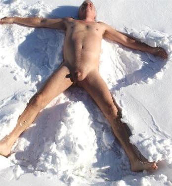 Nude man making a snow angel