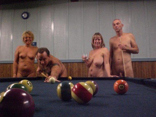 Nudist playing indoor pool