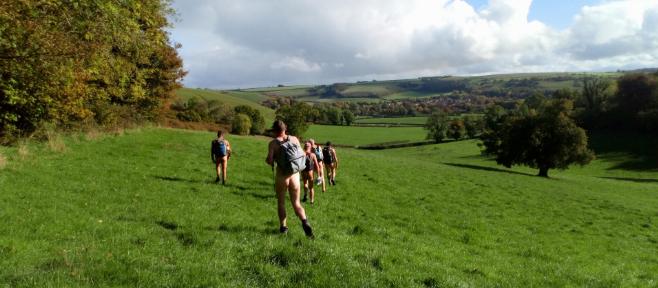 People walking in a field, in the nude