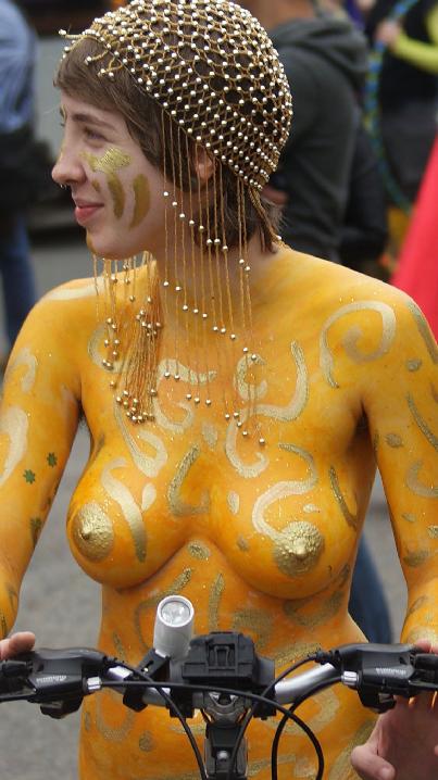 Lady in body paint on a bike