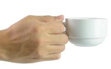 Hand holding a cup of coffee