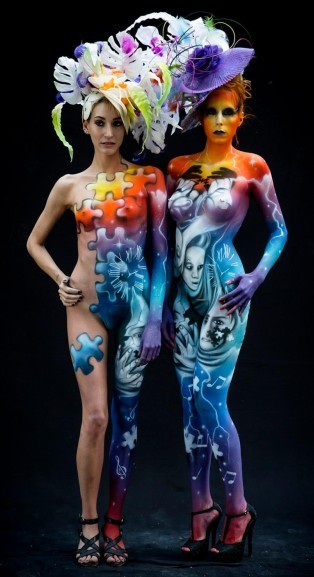 Two body painted ladies with hats