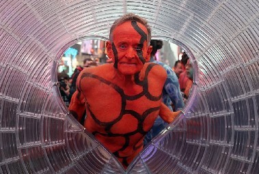 Body painted man, mostly red