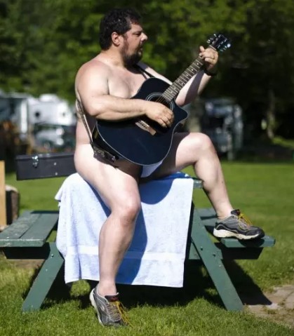 nude man playing guitar